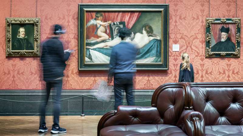 Timelape Blur Of People In Front Of Painting In Gallery 